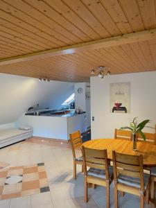 a dining room with a wooden table and chairs at Geräumiges Maisonette Apartment in Todtmoos