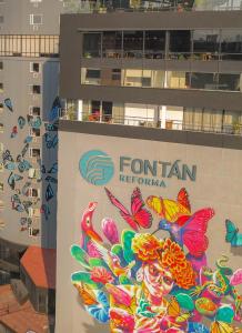 a sign on the side of a building with butterflies at Hotel Fontan Reforma Centro Historico in Mexico City