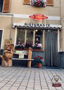 a restaurant with a sign on the front of a building at Spada Reale in Valdieri