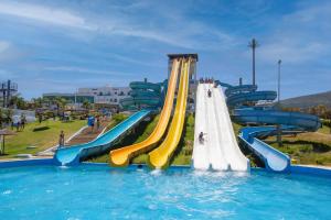 a water slide at a water park with people on it at L'escale Appart-hôtel By 7AV HOTELS in M'diq