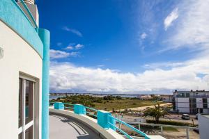 a balcony of a building with a view of the ocean at Lighthouse North Villa - Praia da Barra in Praia da Barra