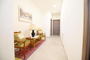 a hallway with a living room with a table and chairs at Artemide B&B in Pianillo