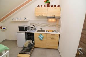 a small kitchen with a sink and a microwave at Artemide B&B in Pianillo +38 photos