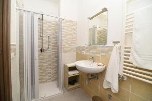 a bathroom with a sink and a shower at Artemide B&B in Pianillo