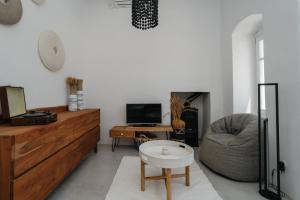 a living room with a couch and a chair at Aillia house in Sifnos