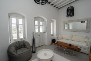a living room with a couch and a chair at Aillia house in Sifnos +44 photos