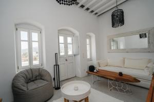 a living room with a couch and a table at Aillia house in Sifnos