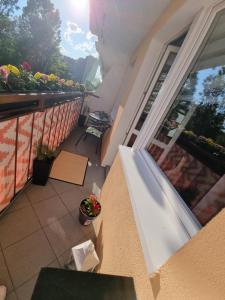 a balcony with a view of a patio with flowers at Apartament Luxusowe Karkonosze in Jelenia Góra