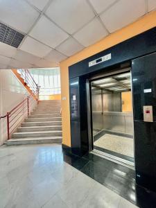 an open elevator in a building with stairs at Apartmani ROZA in Pula