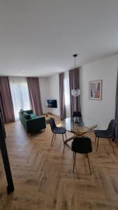 a living room with a green couch and a table at Apartment Noel Cavtat 1 in Cavtat