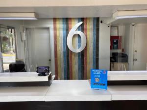 a sign on a wall in an office with a desk at Motel 6-Ardmore, OK in Ardmore +37 photos