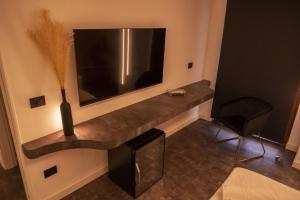 a living room with a large television and a table at Da Placida Al Mare - Luxury B&B Soverato in Soverato Marina