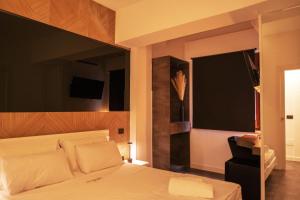 a bedroom with a white bed with a black wall at Da Placida Al Mare - Luxury B&B Soverato in Soverato Marina