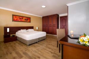 En eller flere senge i et værelse på Hotel Luxor Pereira
