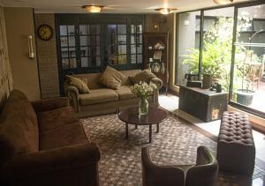 een woonkamer met een bank en een tafel bij Filatelia Suites & Travel in Quito
