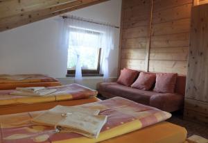 a living room with three beds and a couch at Ranč Podlesok in Hrabušice