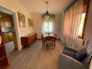 a kitchen and dining room with a table and a couch at Margi House in Bigolino