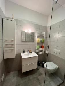 a bathroom with a toilet and a sink and a shower at SeaView Apartments in Koper