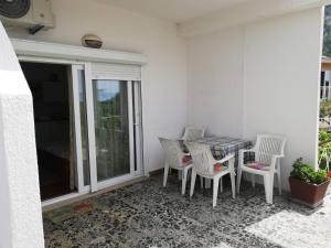 a balcony with a table and chairs on a patio at Apartments Medici in Zaostrog