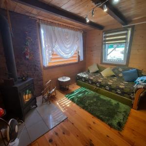 a living room with a couch and a wood stove at U Garnuszka in Krasnopol