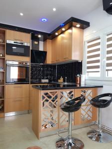 a kitchen with black counter tops and wooden cabinets at Perea 5 star in Perea
