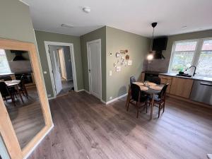 a dining room and kitchen with a table and chairs at Frafjord Apartments Frøya in Dirdal