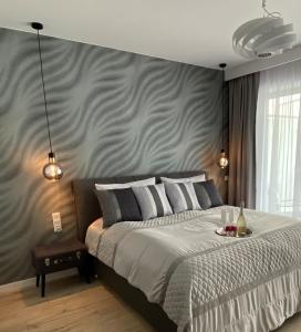斯維諾烏伊希切的住宿－Apartpark Lividus338，一间卧室设有一张大床和灰色的墙壁
