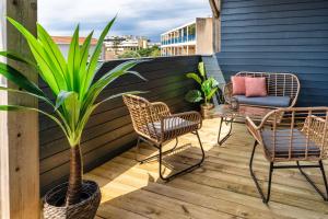 patio z krzesłami, stołem i doniczką w obiekcie Mamita1"Apartment delight of the pines"spacious bright T3 62m18mterrace w mieście Lacanau