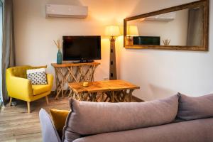 a living room with a couch and a table and a television at MAMITA 2 beautiful spacious and bright apartment T4 74m 18m of terrace in Lacanau-Océan