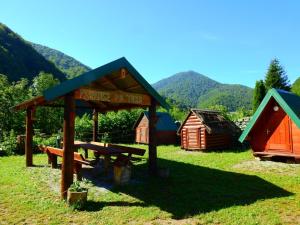a picnic area with a picnic table and tents at Private accommodation Kalezić in Mojkovac