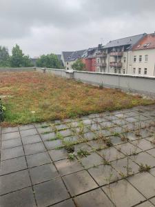 a view of a field of grass and buildings at Apartments K11 für Monteure in Chemnitz in Chemnitz