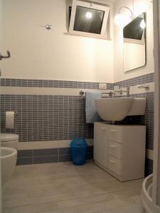 a bathroom with a sink and a toilet at Donnafugata Relais in Marina di Ragusa