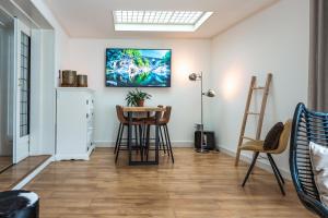 a living room with a table and chairs at Unieke stadswoning met jacuzzi en sauna max 8 pers in Goes