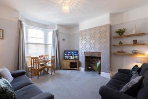 a living room with a couch and a tv and a table at Bootham Apartment 32 - Free Parking - Five minute walk to York Minster in York