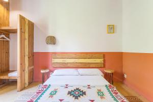 a bedroom with a bed in a room with orange walls at Bird House in Barcelona