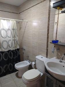 a bathroom with a toilet and a sink at Casa La Comarca in San Rafael
