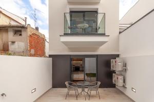un balcon avec des chaises et une table sur un immeuble dans l'établissement Gravito 53 Apartments by Home Sweet Home Aveiro, à Aveiro