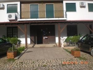 a house with a balcony and a driveway at Capitolio in Macedo de Cavaleiros