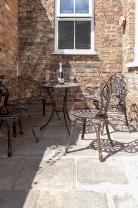 a patio with a table and two chairs and a window at Bootham Apartment 32 - Free Parking - Five minute walk to York Minster in York