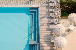 a group of chairs and umbrellas next to a pool at Grand Hotel Bristol Spa Resort, by R Collection Hotels in Rapallo