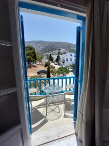 a view from the door of a balcony with a table at ALKYONI STUDIOS in Amorgos