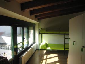 a room with a bunk bed and a window at Albergue Oasis in Sarria +21 photos