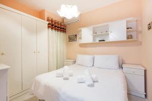 a bedroom with a white bed with towels on it at NE1 - Lovely 2 bedroom apartment. Perfect location in Mellieħa