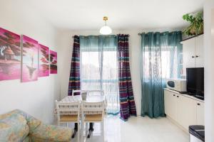 a living room with a table and a window at NE1 - Lovely 2 bedroom apartment. Perfect location in Mellieħa