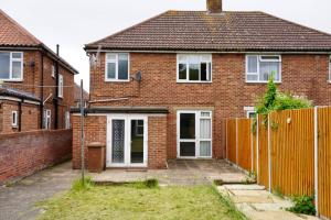 a brick house with a fence in front of it at JDB Chesterfield 3 Bedroom House in Whitton