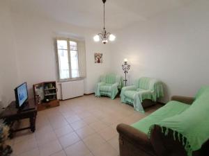 a living room with a couch and two chairs at La Musa di Spello in Spello