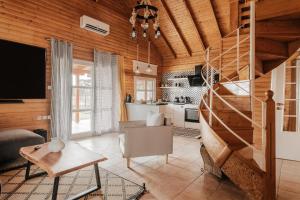 a living room with a staircase and a kitchen at Wood House "Private Spa" in Vergia