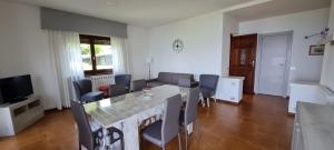 a living room with a dining room table and chairs at APPARTAMENTO BELVEDERE 3 in Stresa