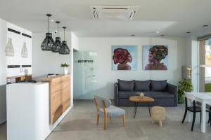 a living room with a couch and a table at Nuovo Crete By Sea - Adults Only in Amoudara Herakliou