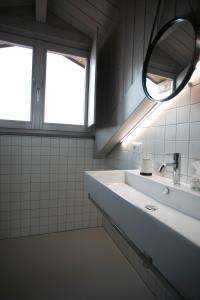 a bathroom with a sink and a mirror at Cibrario Cit Apartment_Square in Turin